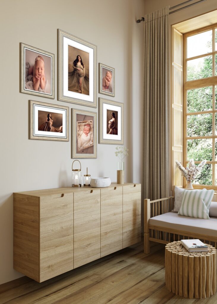 A beige wall features a gallery display of framed maternity and newborn photographs.